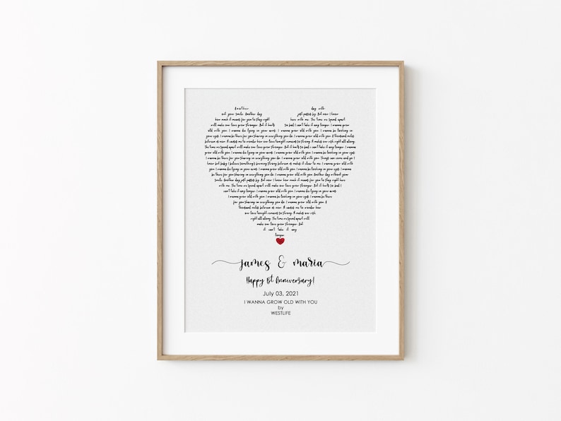 May include: A framed print with a heart-shaped design made of song lyrics. The names "James & Maria" are written in cursive below the heart, with "Happy 6th Anniversary!" and the date July 03, 2021. The song title is "I Wanna Grow Old With You."