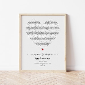 May include: A framed print with a heart-shaped design composed of song lyrics. The print includes the names "James & Maria", the text "Happy 1st Anniversary!", the date "July 03, 2021", and the song title "I WANNA GROW OLD WITH YOU" by WESTLIFE.