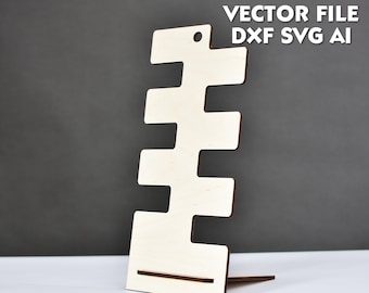 May include: A wooden stand with five slots for displaying earrings or other small jewelry. The stand is made of light wood and has a simple, modern design. VECTOR FILE DXF SVG AI