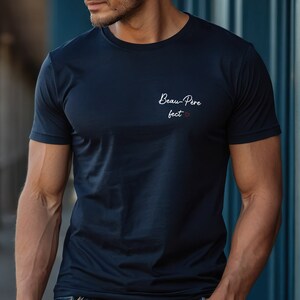 May include: A navy blue t-shirt with the text "Beau-Pere fect" in white with a small red heart.