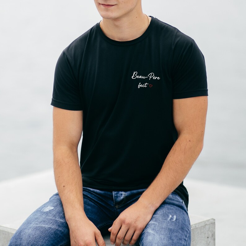 May include: A black t-shirt with the text "Beau-Pere feet" in white with a small red heart.