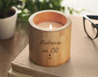 May include: A bamboo candle holder with a white candle inside. The holder is engraved with the text "Maîtresse en OR" and the name "Evan" with a heart symbol.
