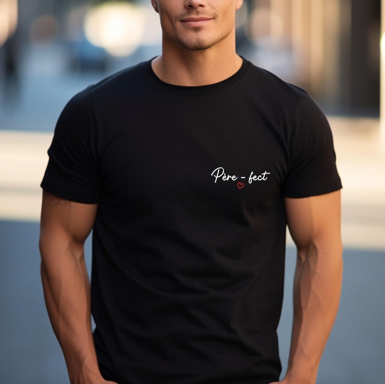 May include: Black crew neck t-shirt with the text "P&egrave;re-fect" in white script and a small red heart. The shirt is made of a soft material.
