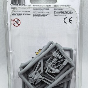 May include: A close-up of a plastic bag containing gray plastic model pieces for a miniature wargaming set. The bag is labeled "Games Workshop Ltd."