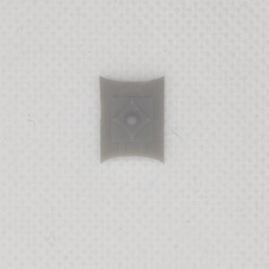 May include: A grey plastic shield with a diamond-shaped design and a small hole in the centre.