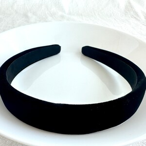 May include: A black velvet headband on a white plate.