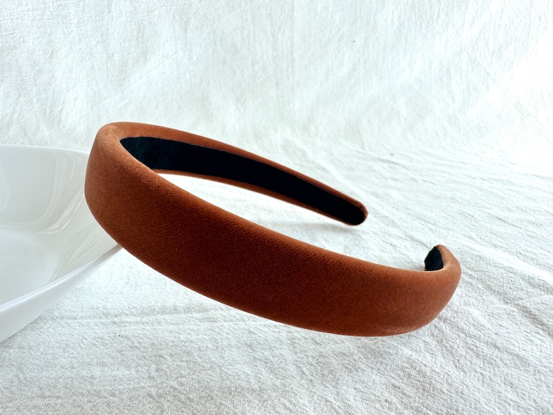 May include: A brown velvet headband with a black elastic band.