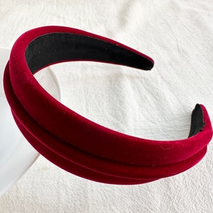May include: A wide, burgundy velvet headband with a double layer of fabric.