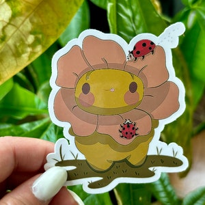 Adesivo rana che indossa un fiore / Graziosa rana in vinile impermeabile con design di coccinelle
