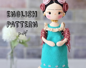 May include: Crochet pattern for a doll with a blue dress, brown hair, and a flower crown. The pattern is in English and is available as a PDF download. The text "ENGLISH PATTERN pdf" is visible in the image.