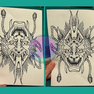 May include: Two black and white line drawings of Japanese demon masks. The masks have sharp teeth and horns. The masks are on white paper.