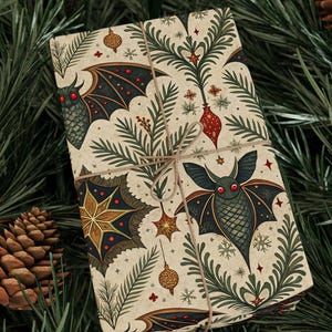 May include: A wrapped gift with a beige background featuring a repeating pattern of bats, stars, and Christmas tree branches. The gift is tied with twine and rests on a bed of green pine needles and pine cones.