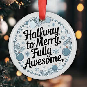 Könnte beinhalten: Ein weißer, runder Weihnachtsschmuck mit dem Text "Halfway to Merry, Fully Awesome" in schwarzer Schrift. Der Schmuck ist mit blauen Ornamenten, Schneeflocken und einem grünen Kranz verziert und hängt an einem roten Band.