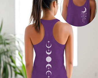 May include: A purple racerback tank top featuring a white moon phase design on the back and a smaller moon and star design on the front. The tank top is made of a soft material and is suitable for workouts or casual wear.