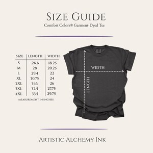 May include: A size guide for Comfort Colors garment-dyed tees. The guide shows measurements in inches for sizes S to 4XL. A dark gray t-shirt is displayed with length and width indicators. The text "ARTISTIC ALCHEMY INK" is at the bottom.