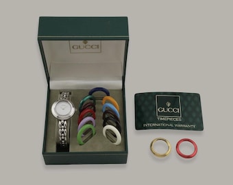 Conjunto de reloj Gucci vintage con bisel de acero, caja y 14 biseles.