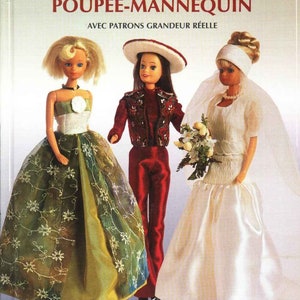 May include: A book titled "20 Tenues Originales Pour Poupée-Mannequin" with a cover featuring three dolls wearing different outfits. The dolls are wearing a green dress, a red and gold outfit, and a white wedding dress. The book includes patterns for making the outfits.