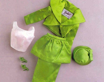 May include: A green outfit for a doll, including a jacket, skirt, trousers, a hat, and a white top. The jacket has a large collar and the label "Barbie® by Mattel" is visible.