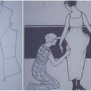 May include: Vintage illustration of a dress pattern and a woman being fitted for a dress. The dress pattern is a line drawing with labeled points. The woman is wearing a long dress, and another woman is kneeling, adjusting the dress.