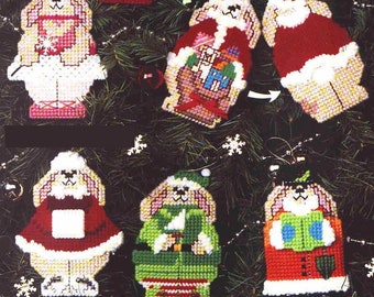 May include: Six handmade Christmas ornaments featuring a bunny dressed in different holiday outfits. The ornaments are made of felt and have a variety of colors, including red, green, white, and pink. The ornaments are perfect for adding a touch of whimsy to your Christmas tree.