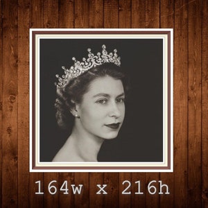 May include: A black and white portrait of Queen Elizabeth II wearing a crown. The image is framed in a brown frame.