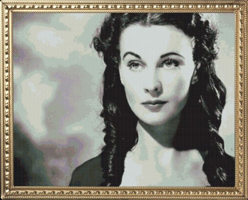 May include: A black and white portrait of a woman with dark hair styled in loose waves. She is wearing a dark dress and has a serious expression on her face.
