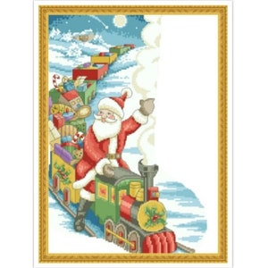 May include: Santa Claus riding a toy train filled with presents. The train is green, red, and yellow with a white smoke plume. The train is on a snowy track with a blue sky and stars in the background.