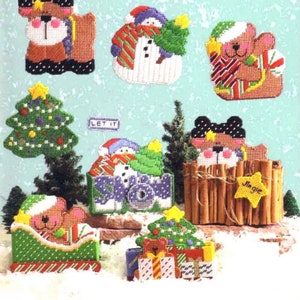 May include: A set of Christmas-themed plastic canvas ornaments featuring bears, snowmen, and Christmas trees. The ornaments are decorated with red, green, white, and brown colors. The ornaments are perfect for adding a festive touch to your home decor.