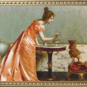 May include: A woman in a long, flowing peach-colored dress is seated at a table with a small dog. She is offering the dog a treat from a plate. The dog is brown and white and has its tongue out.