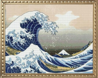 May include: A framed print of a traditional Japanese woodblock print depicting a large blue wave crashing over a boat. The wave is depicted in a dynamic and powerful way, with a sense of movement and energy. The print is framed in a gold frame.