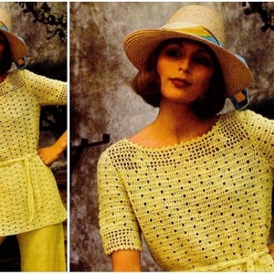May include: A yellow crochet top with a wide, round neckline and short sleeves. The top has a crocheted pattern with small holes throughout. The model is wearing a matching yellow hat.