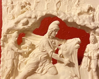 May include: A cream-coloured rectangular relief plaque featuring a central figure wearing a Phrygian cap and tunic, kneeling on a bull. Flanking the central scene are two standing figures holding torches, with additional figures and horses carved in the background.