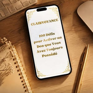 May include: A smartphone displaying a white screen with gold decorative corners and the text: CLAIRVOYANCE 100 Défis pour Activer un Don que Vous Avez Toujours Possédé. The phone is positioned on a wooden surface next to a notebook, a pen, and a keyboard.