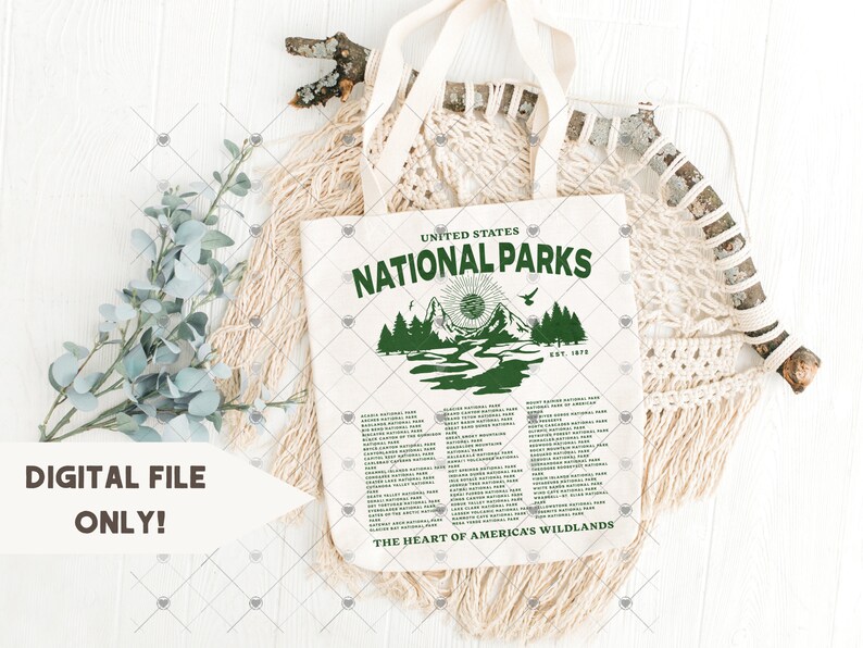 May include: A white tote bag with a green graphic of a mountain scene and the text "United States National Parks Est. 1916 The Heart of America's Wildlands". The bag has a list of all the national parks in the United States.