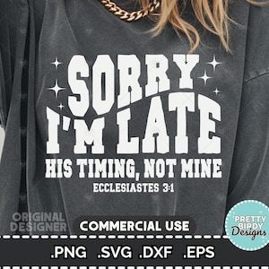 May include: Dark gray t-shirt with the text "SORRY I'M LATE" in large white letters. Below, it reads "HIS TIMING, NOT MINE" and "ECCLESIASTES 3:1". The shirt has a vintage, worn look.