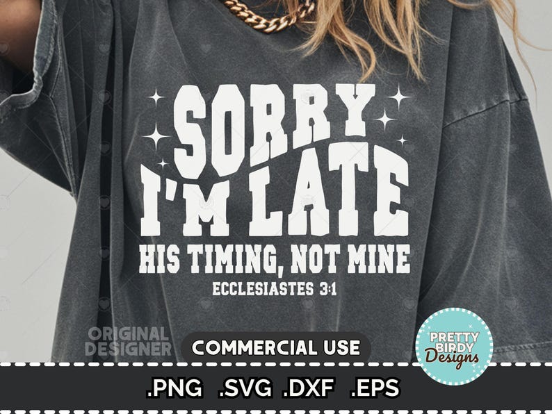 May include: Dark gray t-shirt with the text "SORRY I'M LATE" in large white letters. Below, it reads "HIS TIMING, NOT MINE" and "ECCLESIASTES 3:1". The shirt has a vintage, worn look.