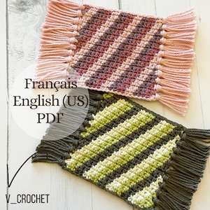 May include: Two crocheted coasters with fringe. One coaster is pink and purple with diagonal stripes. The other coaster is green and grey with diagonal stripes. The text "Français English (US) PDF" is visible in the image.