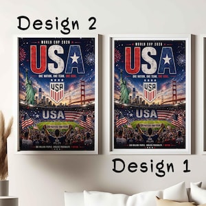 May include: Two framed posters titled Design 2 and Design 1, featuring a World Cup 2026 graphic. The artwork displays the Statue of Liberty, the Golden Gate Bridge, a soccer stadium, and the text USA, One Nation, One Team, One Goal.