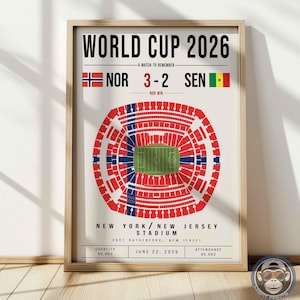 May include: A framed poster titled WORLD CUP 2026 featuring a stadium graphic with a Norwegian flag overlay. It displays the score NOR 3-2 SEN, the location New York/New Jersey Stadium, East Rutherford, New Jersey, and the date June 22, 2026.