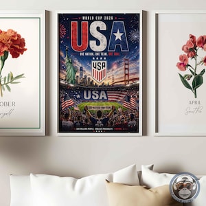 May include: A vertical wall art print featuring a World Cup 2026 USA theme. The design displays the Statue of Liberty, the Golden Gate Bridge, a soccer stadium filled with fans, the USA soccer crest, and the text USA, One Nation, One Team, One Goal.