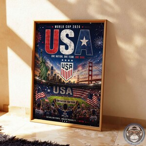 May include: A framed poster for the World Cup 2026 featuring the text USA, the Statue of Liberty, the Golden Gate Bridge, and a soccer stadium filled with fans. The design includes American flags, a team crest, and the slogan One Nation, One Team.
