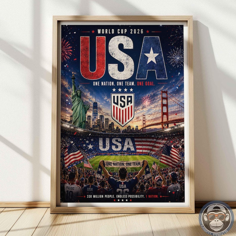 May include: A framed poster for the World Cup 2026 featuring the text USA, One Nation. One Team. One Goal. The image displays the Statue of Liberty, the Golden Gate Bridge, a soccer stadium filled with fans, and the USA soccer team crest.