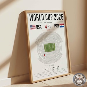 May include: A framed poster titled World Cup 2026 featuring a stadium map with a highlighted red seat. It displays the text USA 4-1 PAR, the flags of the USA and Paraguay, and details including SoFi Stadium, Inglewood, California, Section 123, Row 14, Seat 22, and June 12, 2026.