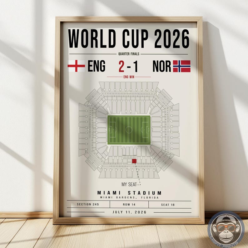 May include: A framed poster titled WORLD CUP 2026 featuring a stadium map, the score ENG 2-1 NOR, and text indicating MIAMI STADIUM, MIAMI GARDENS, FLORIDA, SECTION 245, ROW 14, SEAT 18, JULY 11, 2026, with a red square marking a specific seat location.