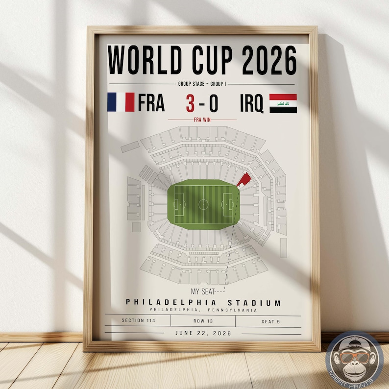 May include: A framed poster titled WORLD CUP 2026 displaying a match between France and Iraq with a 3-0 score. It features a top-down diagram of Philadelphia Stadium with a highlighted seat in section 114, row 13, seat 5, dated June 22, 2026.