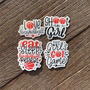 May include: Four white stickers with black and red text and basketball graphics. The stickers read 