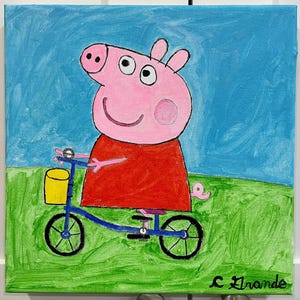 Peppa Pig montando su bicicleta