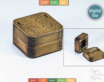 Puede incluir: Una caja de anillo de madera con un diseño floral. La caja está hecha de madera de 3 mm de grosor y tiene una tapa con bisagras. La caja está abierta y se ve un anillo en el interior. La caja está etiquetada como "Unique Creations".