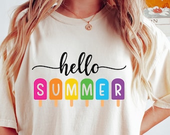 May include: A white t-shirt with the text "hello summer" printed on it. The letters are in rainbow colors and are shaped like popsicles.