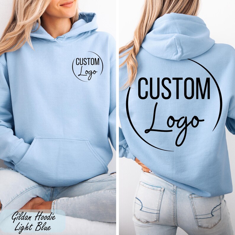 A woman wearing a light blue hoodie with the text "CUSTOM Logo" printed on the back.